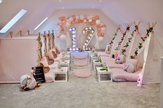 a room filled with lots of pink and white decorations on top of carpeted floors