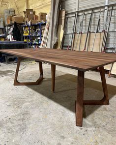 a large wooden table sitting in a warehouse