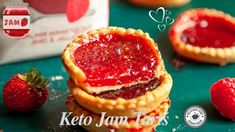 three strawberry jam tarts stacked on top of each other next to some strawberries