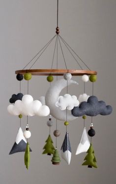 a mobile with clouds and trees hanging from it