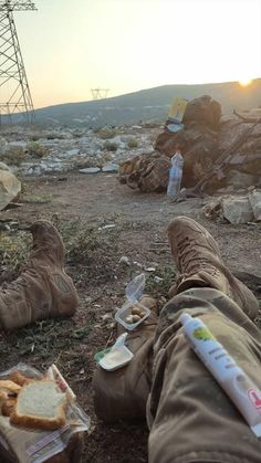 a person laying on the ground with food in front of him