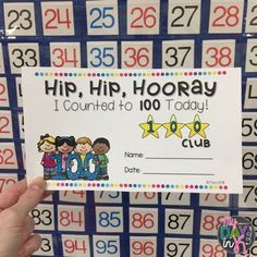 a hand holding up a sign that says hip, hip hooray i counted to 100 today