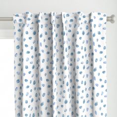 a white curtain with blue spots on it