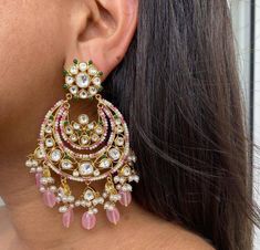 These chandbali features exquisite kundan worklined with pretty pink quartz stones and pearls. The bottom cresent moon shaped part has small kundan unit hangings with tufts of pearls and green beads. Closure - Push Back Style Tip - This whimsical chandbali with hints of flamboyance will surely be your go to jewel for any and every traditional occassion. These poetically detailed earrings are for all the lovers of old world romances. Add a touch of romanticism and flamboyance to your outfit with Pink Kundan Earrings, Luxury Chandbali Bridal Earrings For Festivals, Cheap Traditional Chandbali Chandelier Earrings, Cheap Bollywood Style Chandbali Earrings, Cheap Chandbali Bridal Earrings, Pink Indian Earrings, Luxury Chandbali Bridal Earrings, Luxury Chandbali Danglers For Party, Luxury Chandbali Jewelry For Celebration