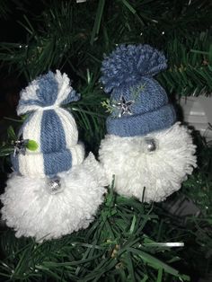 two white and blue hats hanging from a christmas tree