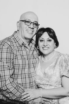 black and white photograph of a man and woman smiling at the camera with their arms around each other