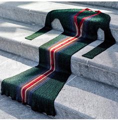 a green and red striped rug sitting on top of some concrete steps with the words beyondthemag above it