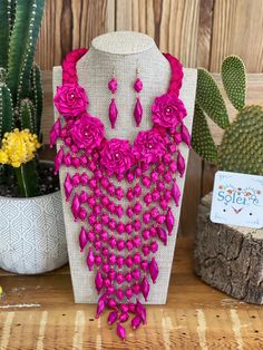 Beautiful Jewelry set made with Palm Tree Leaves hand woven into flowers and beads. This elegant jewelry is Handmade With love by Mexican Artisans in Michoacán, Mexico. Pair with your favorite outfit and you will be the star of the show with this completely unique and handmade jewelry. Includes earrings and necklace. MORE JEWELRY HERE: https://www.etsy.com/es/shop/SoleiEthnic?ref=seller-platform-mcnav&section_id=25467804 Pink Bohemian Jewelry With Handmade Flowers, Bohemian Pink Jewelry With Handmade Flowers, Pink Flower-shaped Jewelry With Dangling Beads, Pink Flower Jewelry With Dangling Beads, Pink Flower Jewelry For Celebration, Flower Shaped Faceted Beads For Jewelry Making, Day Of Dead Costume, Mexican Necklace, Palm Necklace