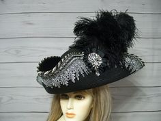 "Wowza! One of a kind. Love this oversized black faux straw pirate hat with grey Venise lace with hand placed glass rhinestones on each point, matching braid and trim, waterfall of black ostrich feathers, black cocarde with a jewel center. This is a standout pirate hat. the upturn brim is about 5\". Please measure your head, this hat is 22.5\" for the inside circumference with a built-in hat sizer string. I cannot make the circumference bigger so please keep that in mind. All sales are final. Check out my other pirate hats and goodies in my shop. Please let me know if you have any questions.   All sales are FINAL, no returns or exchanges please keep this in mind before purchasing." Pirate Tricorn Hat, Pirate Hat Diy, Diy Pirate Hat, Pirate Garb, Tricorn Hat, Black Pirate, Pirate Wedding, Pirate Costumes, Snake Hair