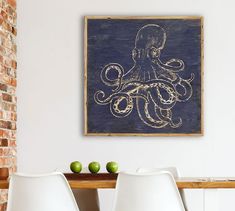 an octopus is on the wall above two white chairs