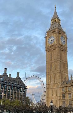 the big ben clock tower towering over the city of london, england with ferris wheel in the background