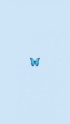 a blue butterfly flying in the sky with no clouds on it's back side