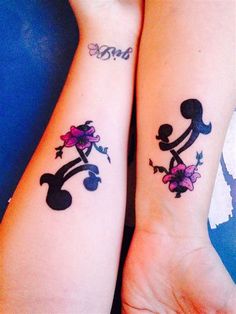 two people with matching tattoos on their arms