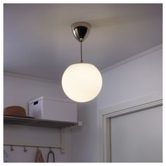 a white light hanging from the ceiling in a kitchen