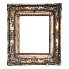 an ornate gold frame with flowers and leaves on the edges, hanging from a wall