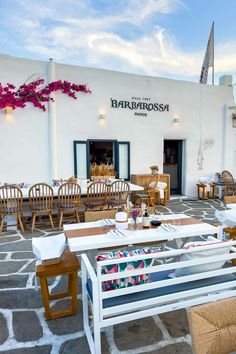 an outdoor dining area with tables, chairs and umbrellas on the patio at barbossa