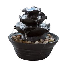 a black bowl with rocks and water pouring from it