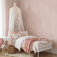 a bedroom with pink walls and white furniture