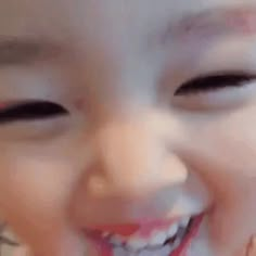 a close up of a child's face smiling