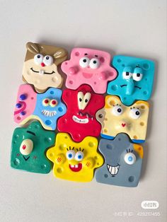 a group of different colored plastic toys with eyes and mouth shapes on top of each other