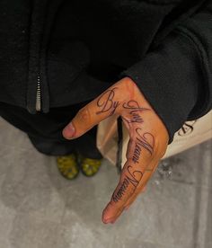 a person's hand with some writing on it