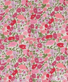 a pink and green floral print fabric with red flowers on the bottom half of it