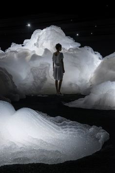 a woman standing in an ice cave looking at the ground below her is text about how to get there