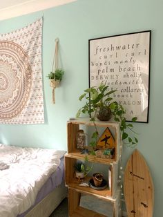 a bed room with a neatly made bed next to a wall hanging on the wall