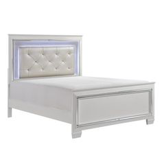 a white bed with an upholstered headboard and foot board is shown in front of a white background