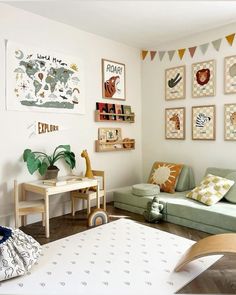 a living room filled with furniture and pictures on the wall next to a baby's crib