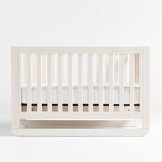 a white crib with no sheets on the bottom and black trim around the sides