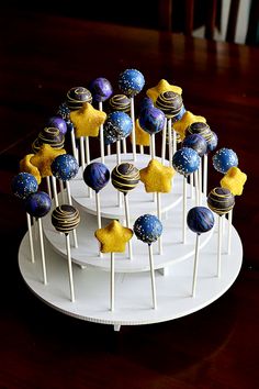 an image of cake pops on a plate with stars and planets in the top one