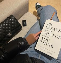 a person sitting on a couch with a book in their lap reading 101 ways to change the way you think