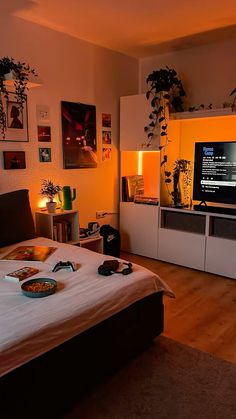 a bed room with a neatly made bed and a flat screen tv on the wall