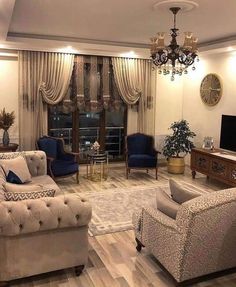 a living room filled with furniture and a chandelier