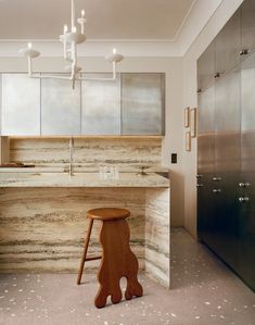 a kitchen with marble counter tops and wooden stools