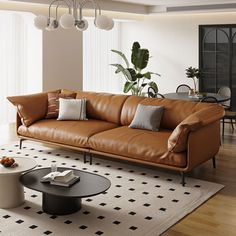 a living room filled with furniture and a potted plant on top of a table