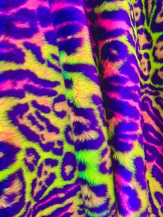 several different colored animal print fabrics are shown in close up, with the colors changing from green to purple