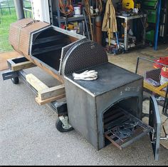 an outdoor bbq grill sitting in the middle of a garage