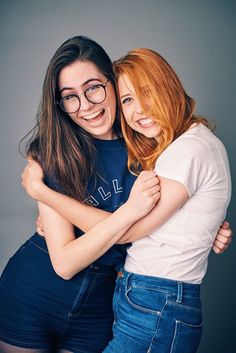 two young women hugging each other and smiling