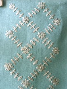 an embroidered piece of cloth with white crosses on it