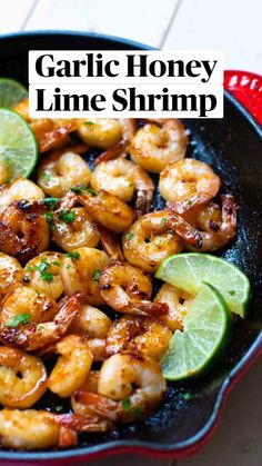 a skillet filled with shrimp and lime slices