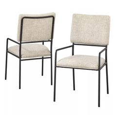 a pair of chairs with beige upholstered fabric and black metal frame, on white background