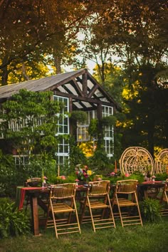 an outdoor dining table set up in the middle of a garden with lots of greenery