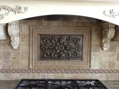 an ornately decorated fireplace surround in a kitchen