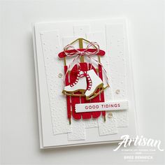 a handmade christmas card with a pair of ice skates hanging from it's side