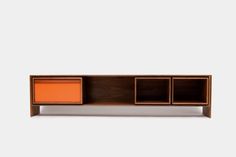 the sideboard is made from wood and has an orange cabinet on one side, and two