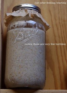 a jar filled with lots of white stuff on top of a wooden table