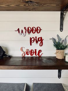 a sign that says woop pig some on top of a shelf