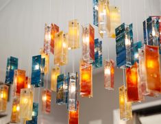 a chandelier made out of glass blocks hanging from the ceiling